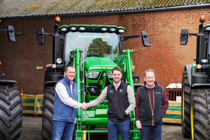 Ironhide Tractor & Equipment team handing over a new tractor